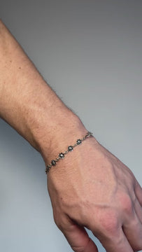 Nox 925 sterling silver bracelet with delicate floral-shaped links and a fine chain